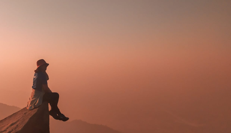 Girl sitting on a mountain area